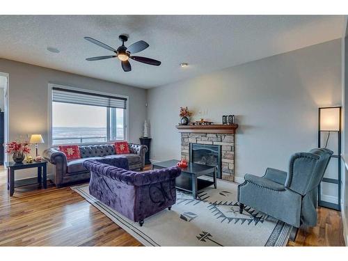 163 Sunset View, Cochrane, AB - Indoor Photo Showing Living Room With Fireplace