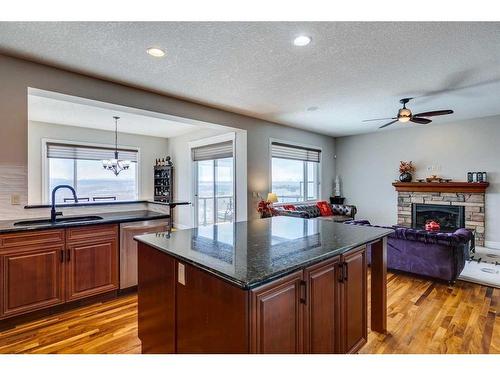 163 Sunset View, Cochrane, AB - Indoor Photo Showing Kitchen With Fireplace