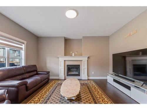 255 Baywater Way Sw, Airdrie, AB - Indoor Photo Showing Living Room With Fireplace