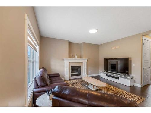 255 Baywater Way Sw, Airdrie, AB - Indoor Photo Showing Living Room With Fireplace
