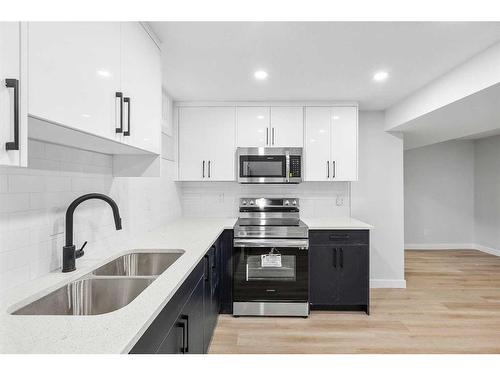 7645 & 7643 21A Street Se, Calgary, AB - Indoor Photo Showing Kitchen With Stainless Steel Kitchen With Double Sink With Upgraded Kitchen