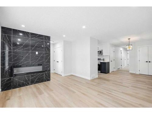 7645 & 7643 21A Street Se, Calgary, AB - Indoor With Fireplace