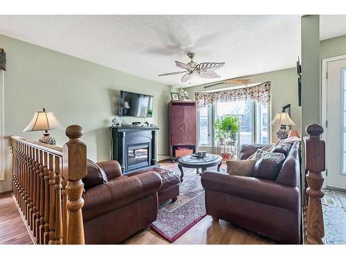 14 Hunters Gate, Okotoks, AB - Indoor Photo Showing Living Room With Fireplace