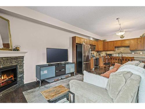 409-300 Palliser Lane, Canmore, AB - Indoor Photo Showing Living Room With Fireplace