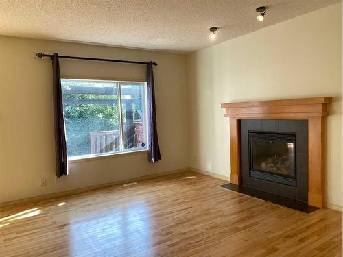 195 Brightonstone Gardens Se, Calgary, AB - Indoor Photo Showing Living Room With Fireplace
