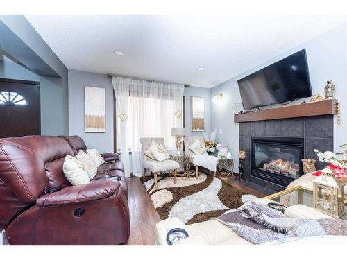 222 Saddlebrook Way Ne, Calgary, AB - Indoor Photo Showing Living Room With Fireplace