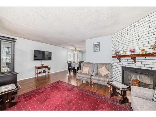 19 Falchurch Road Ne, Calgary, AB - Indoor Photo Showing Living Room With Fireplace
