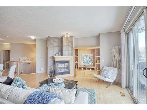 135 Everglade Way Sw, Calgary, AB - Indoor Photo Showing Living Room With Fireplace