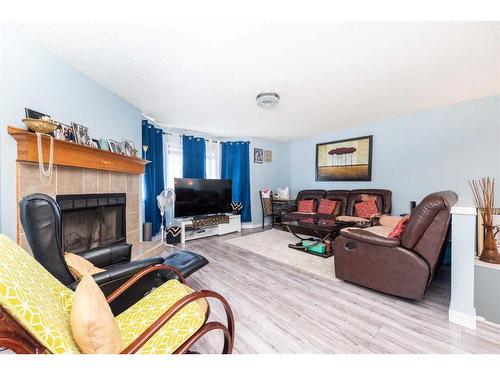 145 Hidden Spring Circle Nw, Calgary, AB - Indoor Photo Showing Living Room With Fireplace