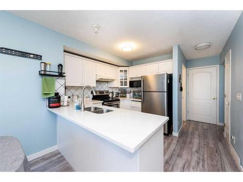 145 Hidden Spring Circle Nw, Calgary, AB - Indoor Photo Showing Kitchen With Double Sink