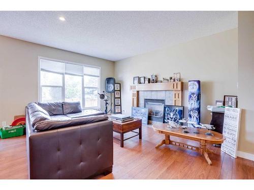 24 Copperstone Place Se, Calgary, AB - Indoor Photo Showing Living Room With Fireplace