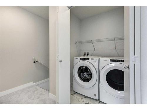 202-335 Creekside Boulevard, Calgary, AB - Indoor Photo Showing Laundry Room