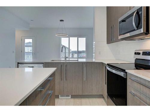 202-335 Creekside Boulevard, Calgary, AB - Indoor Photo Showing Kitchen With Upgraded Kitchen
