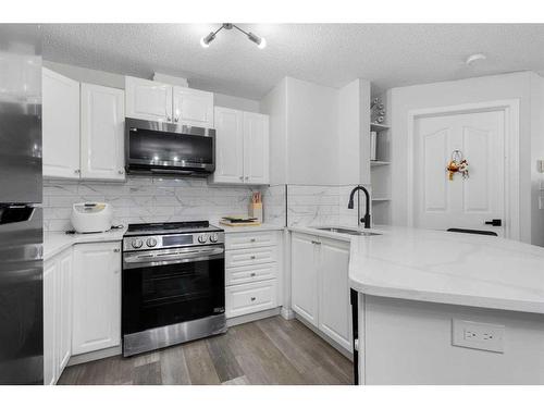 211-6000 Somervale Court Sw, Calgary, AB - Indoor Photo Showing Kitchen With Double Sink