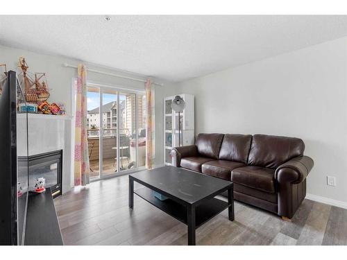 211-6000 Somervale Court Sw, Calgary, AB - Indoor Photo Showing Living Room With Fireplace
