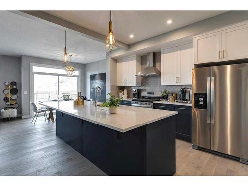 156 Sunrise Common, Cochrane, AB - Indoor Photo Showing Kitchen With Upgraded Kitchen