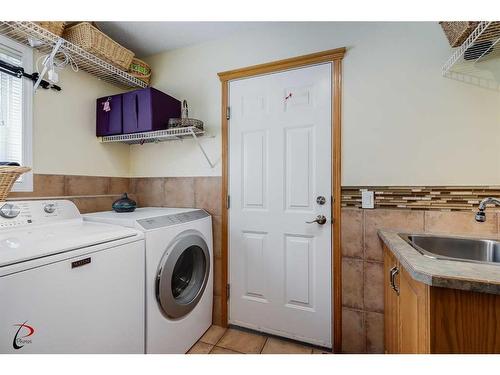 77 Rockbluff Place Nw, Calgary, AB - Indoor Photo Showing Laundry Room