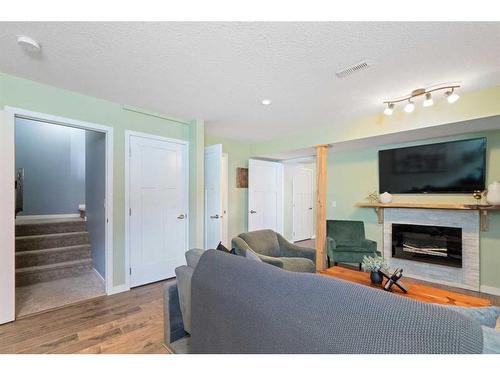 48 Sage Bluff Green Nw, Calgary, AB - Indoor Photo Showing Living Room With Fireplace