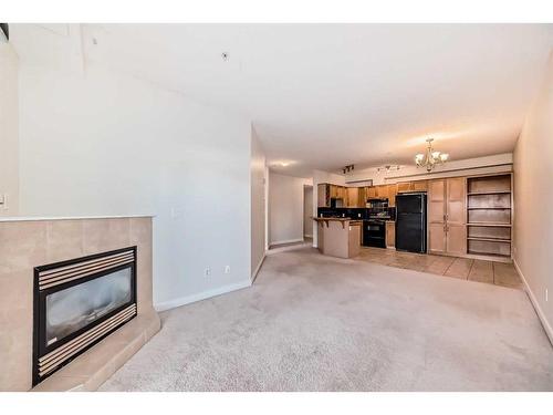 320-1800 14A Street Sw, Calgary, AB - Indoor Photo Showing Living Room With Fireplace