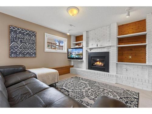 259 Sandstone Road Nw, Calgary, AB - Indoor Photo Showing Living Room With Fireplace
