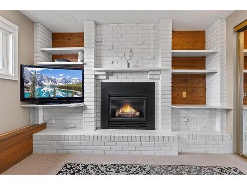 259 Sandstone Road Nw, Calgary, AB - Indoor Photo Showing Other Room With Fireplace