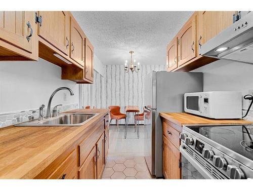 305-635 57 Avenue Sw, Calgary, AB - Indoor Photo Showing Kitchen With Double Sink
