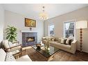 208 Mahogany Grove Se, Calgary, AB  - Indoor Photo Showing Living Room With Fireplace 