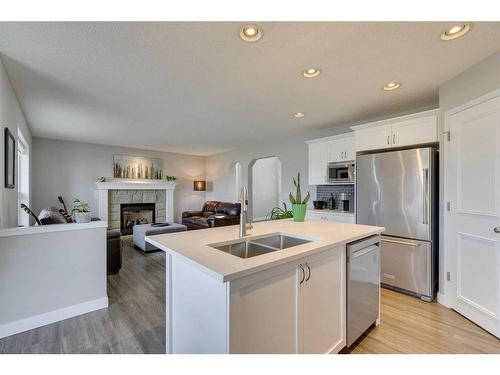 20 Tuscany Ravine Court Nw, Calgary, AB - Indoor Photo Showing Kitchen With Fireplace With Double Sink With Upgraded Kitchen