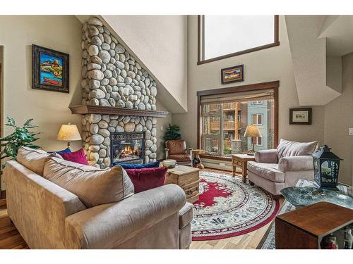 319-175 Crossbow Place, Canmore, AB - Indoor Photo Showing Living Room With Fireplace