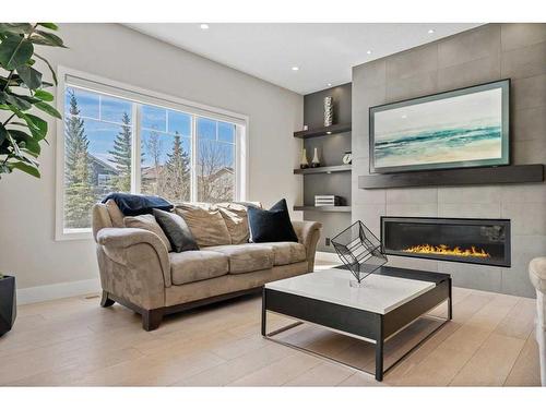 49 Cougar Ridge Close Sw, Calgary, AB - Indoor Photo Showing Living Room With Fireplace