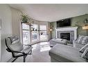 34 Cramond Crescent Se, Calgary, AB  - Indoor Photo Showing Living Room With Fireplace 