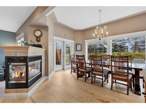 163 Strathridge Place Sw, Calgary, AB - Indoor Photo Showing Dining Room With Fireplace