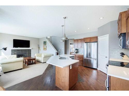 104 Prestwick Manor Se, Calgary, AB - Indoor Photo Showing Kitchen With Fireplace