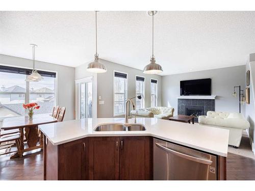 104 Prestwick Manor Se, Calgary, AB - Indoor Photo Showing Kitchen With Fireplace With Double Sink