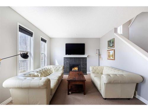 104 Prestwick Manor Se, Calgary, AB - Indoor Photo Showing Living Room With Fireplace