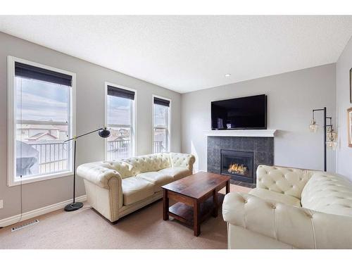 104 Prestwick Manor Se, Calgary, AB - Indoor Photo Showing Living Room With Fireplace