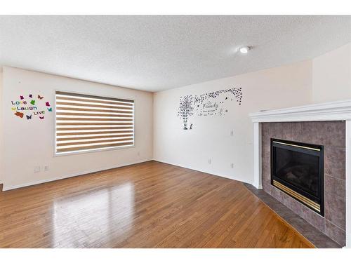 196 Everwillow Green Sw, Calgary, AB - Indoor Photo Showing Living Room With Fireplace