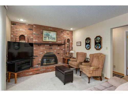 10727 Willowfern Drive Se, Calgary, AB - Indoor Photo Showing Living Room With Fireplace