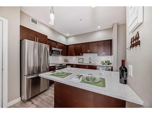 109-10 Auburn Bay Link Se, Calgary, AB - Indoor Photo Showing Kitchen With Stainless Steel Kitchen