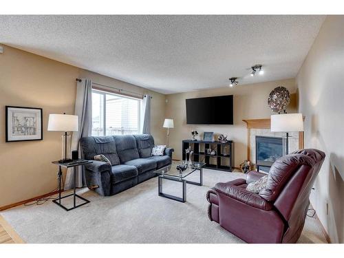 332 Cranfield Gardens Se, Calgary, AB - Indoor Photo Showing Living Room With Fireplace