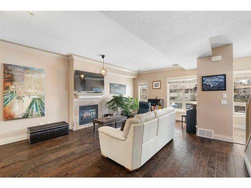 107-1728 35 Avenue Sw, Calgary, AB - Indoor Photo Showing Living Room With Fireplace