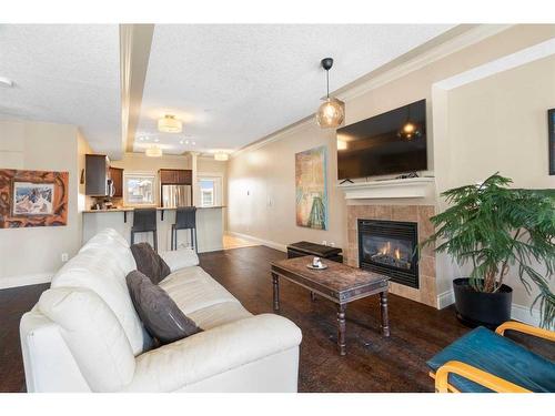 107-1728 35 Avenue Sw, Calgary, AB - Indoor Photo Showing Living Room With Fireplace