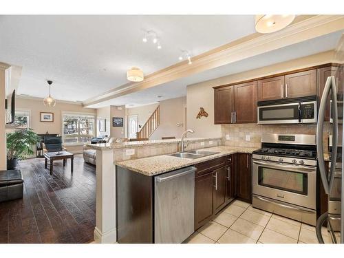 107-1728 35 Avenue Sw, Calgary, AB - Indoor Photo Showing Kitchen With Double Sink