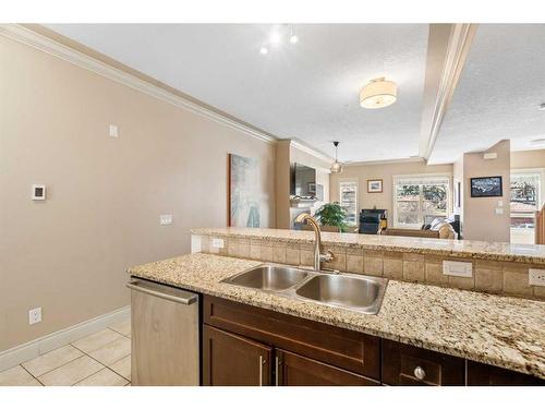 107-1728 35 Avenue Sw, Calgary, AB - Indoor Photo Showing Kitchen With Double Sink