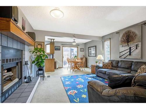 240 Shawinigan Place Sw, Calgary, AB - Indoor Photo Showing Living Room With Fireplace