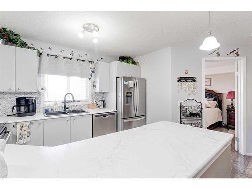 8429-304 Mackenzie Way Sw, Airdrie, AB - Indoor Photo Showing Kitchen With Double Sink