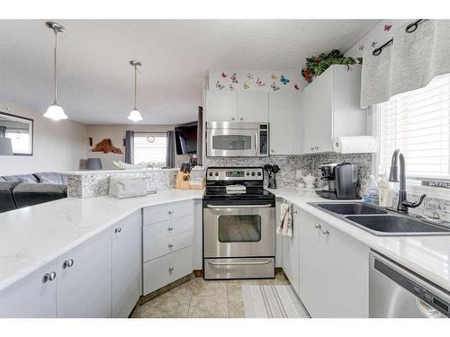 8429-304 Mackenzie Way Sw, Airdrie, AB - Indoor Photo Showing Kitchen With Double Sink With Upgraded Kitchen