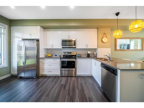 12-138 Seton Passage Se, Calgary, AB - Indoor Photo Showing Kitchen With Stainless Steel Kitchen With Double Sink With Upgraded Kitchen