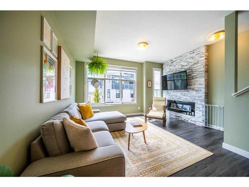 12-138 Seton Passage Se, Calgary, AB - Indoor Photo Showing Living Room With Fireplace