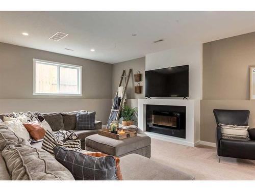 667 West Highland Crescent, Carstairs, AB - Indoor Photo Showing Living Room With Fireplace